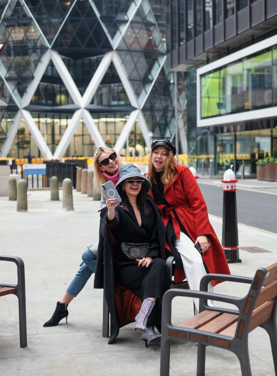 Friends taking a selfie in the city, an ideal spot for Airbnb management Manchester near iconic landmarks.