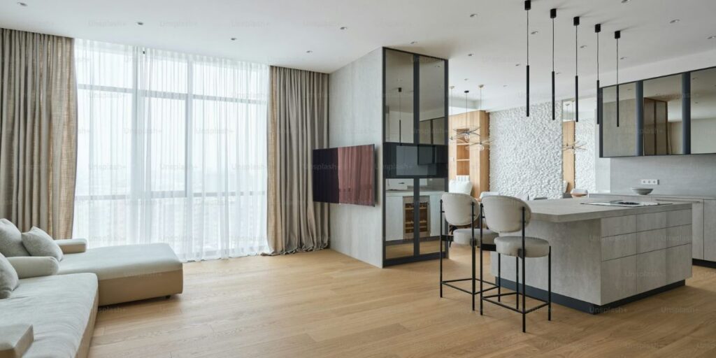 Modern, open-plan Liverpool property featuring a chic kitchen island and a spacious living area.