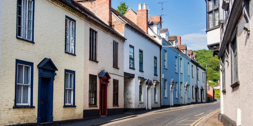 A row of colorful terraced houses on a street, showcasing traditional Liverpool property architecture.
